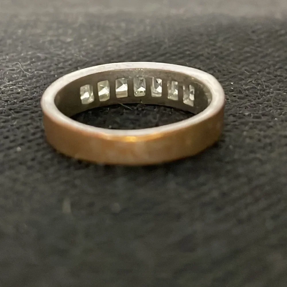 Metal ring with a row of white gems